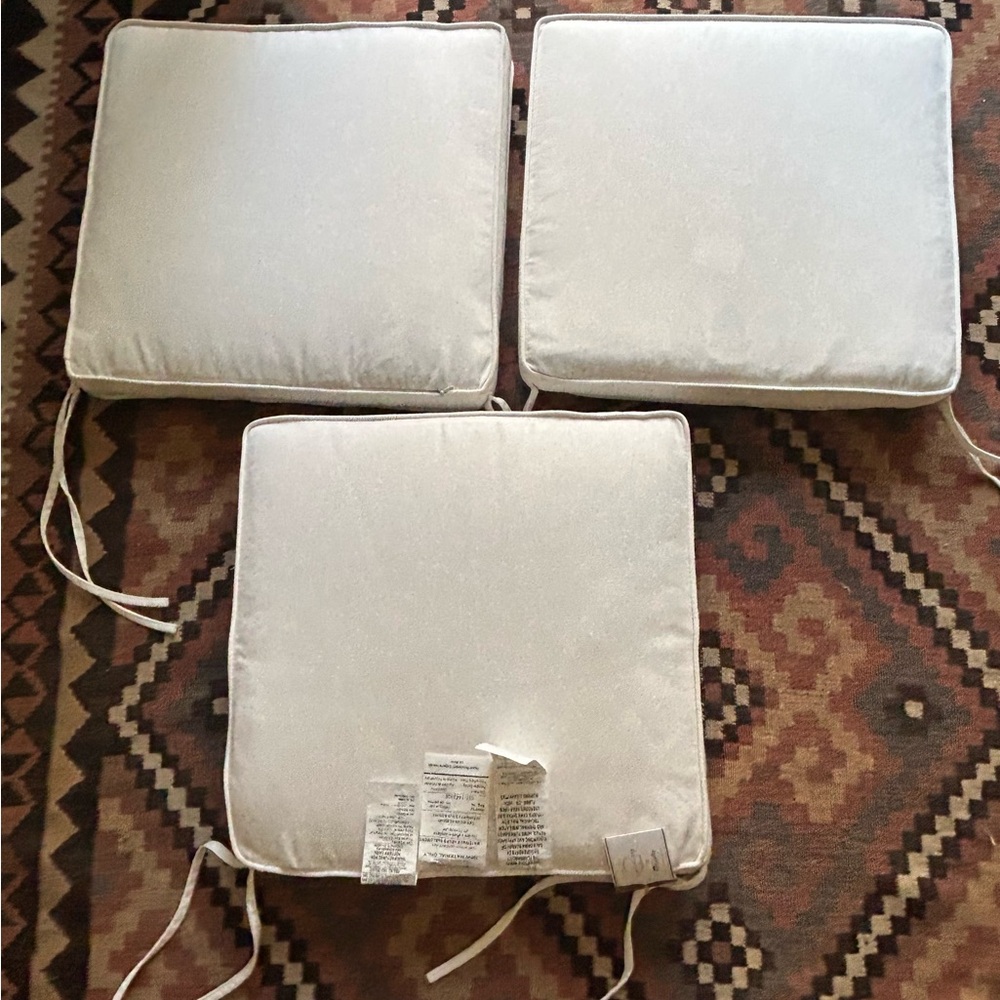 Three Pottery Barn Sunbrella outdoor chair cushions